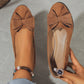 Loafers med kilklack och dekor av rosettknut