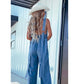 V-ringad ärmlös sexig jumpsuit med öppen rygg i tvättad denim